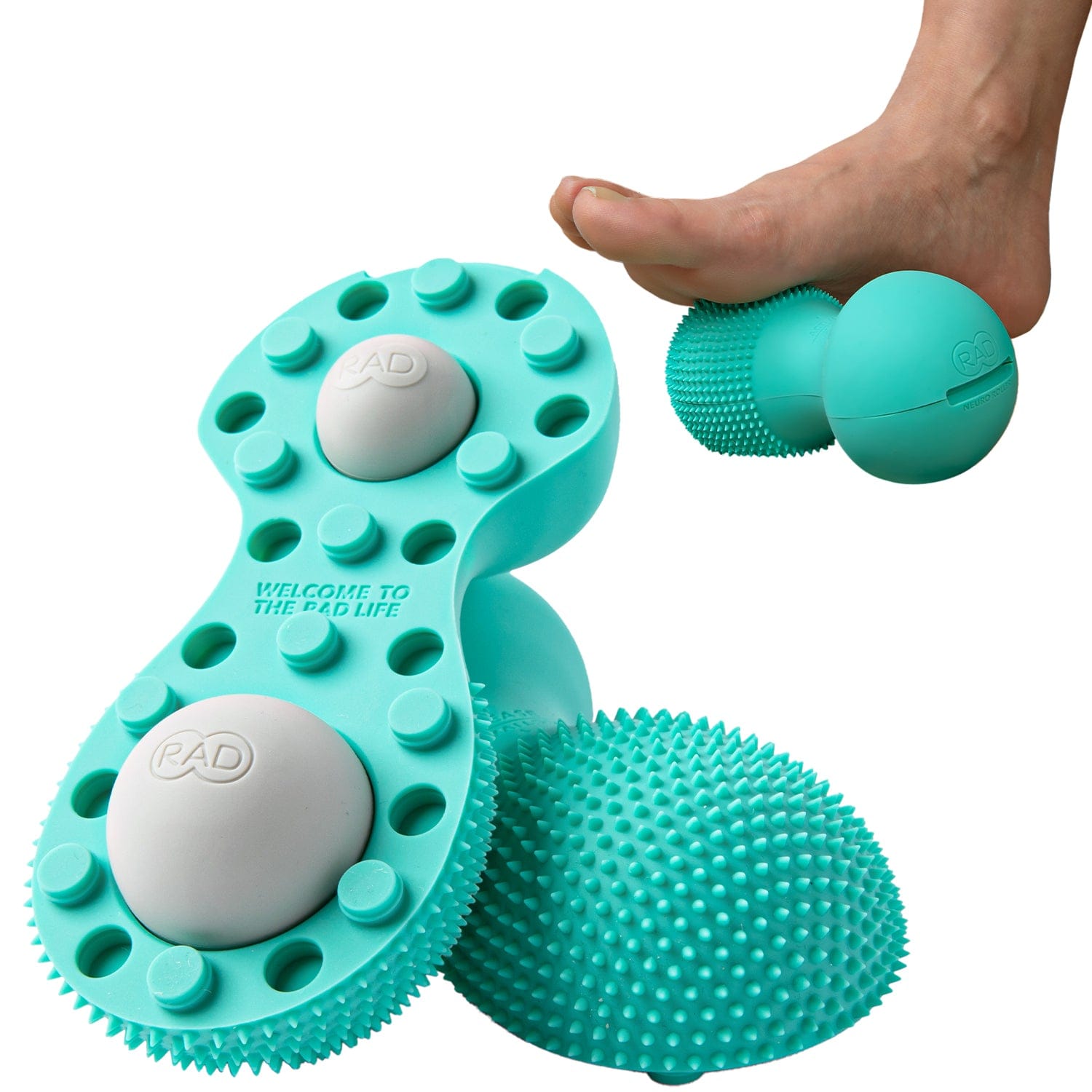 Turquoise massage tool with textured surface and 'PAD' branding, used on a foot.